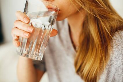 Woman drinking a glass of clean, safe, purified water in Orlando, FL